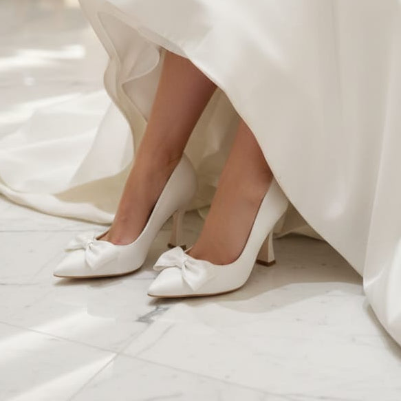 White bridal shoes with a wedding gown in a room setting.